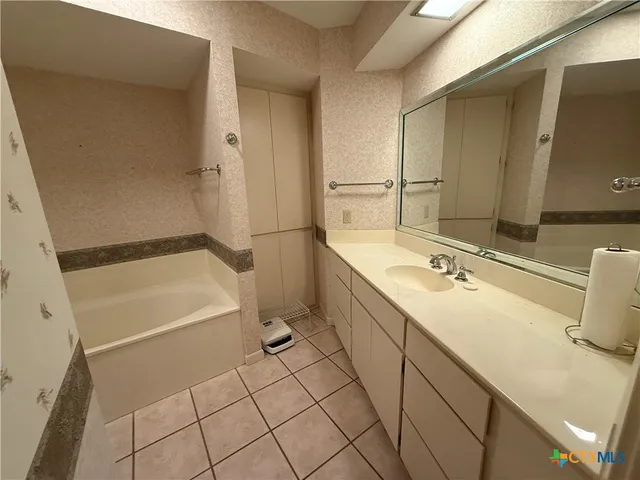 a bathroom with a bathtub and shower