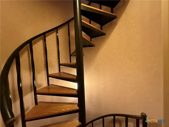 a view of a balcony with furniture and umbrella