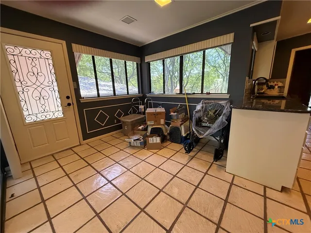 a kitchen with a sink a stove and cabinets