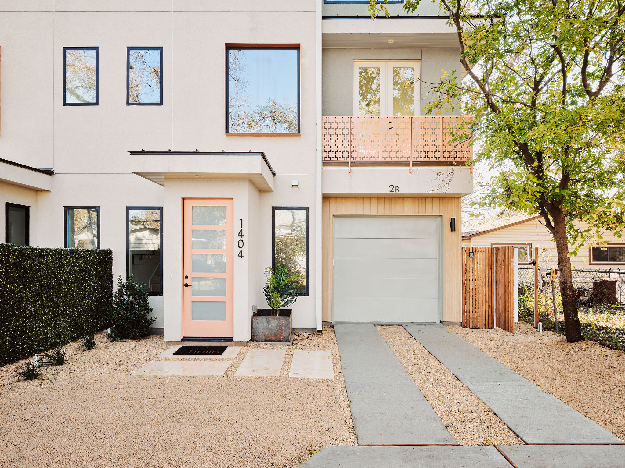 View of front of home with stucco siding, concrete driveway, and a garage