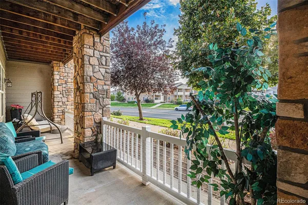 a view of a porch with furniture and garden
