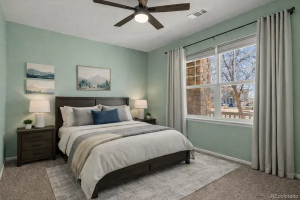 a bedroom with a bed and a painting on the wall