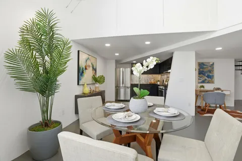a living room with furniture potted plant and a window