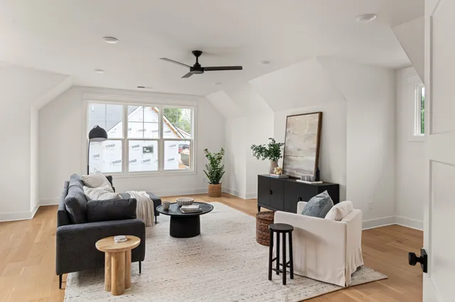 a living room with furniture a window and a flat screen tv