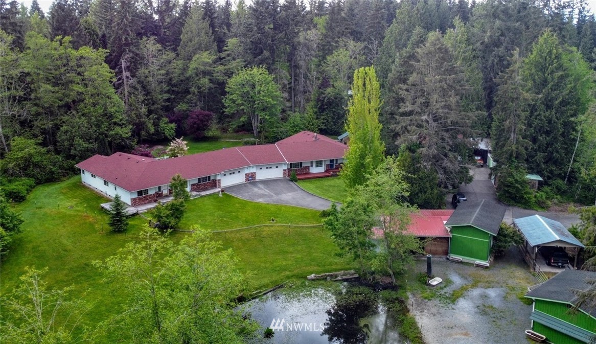 an aerial view of house with yard swimming pool and outdoor seating