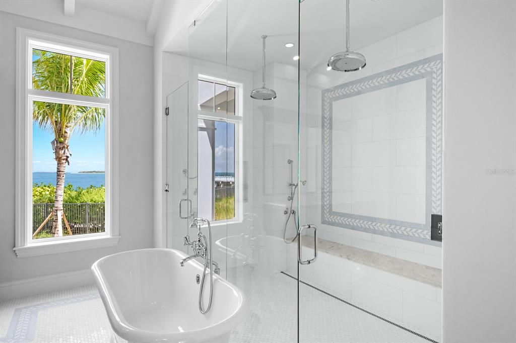 894 Hill Tide Lane Boca Grande, FL 33921 - Photo 70 of 100 a bathroom with a granite countertop sink a mirror and a bathtub