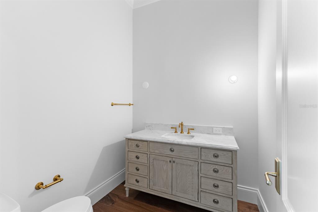 894 Hill Tide Lane Boca Grande, FL 33921 - Photo 74 of 100 a utility room with cabinets washer and dryer