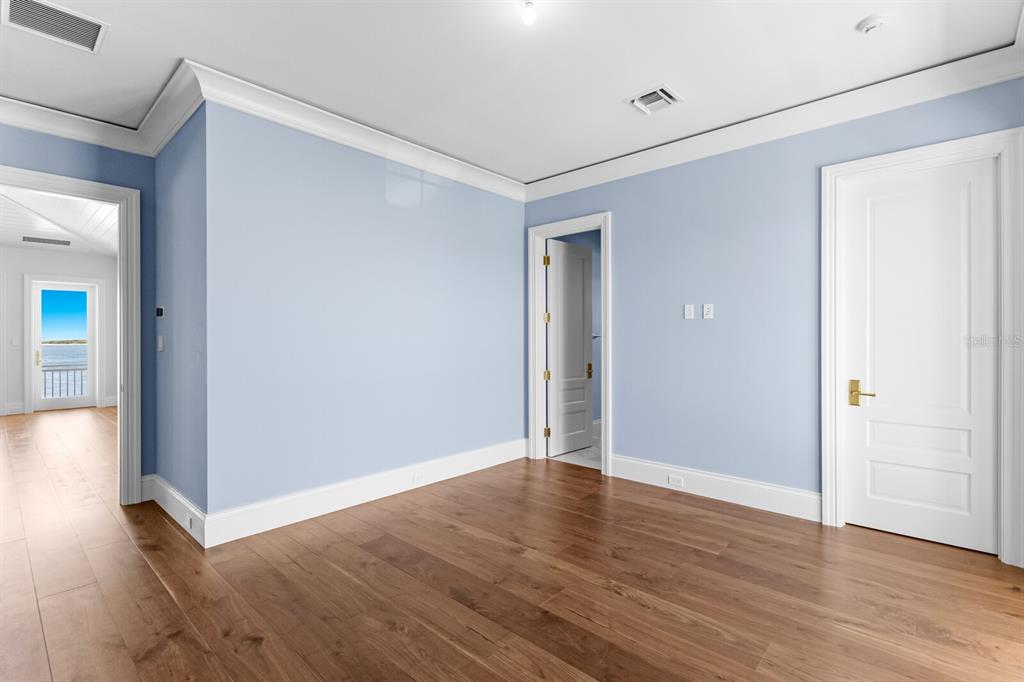 894 Hill Tide Lane Boca Grande, FL 33921 - Photo 89 of 100 a view of an empty room with wooden floor