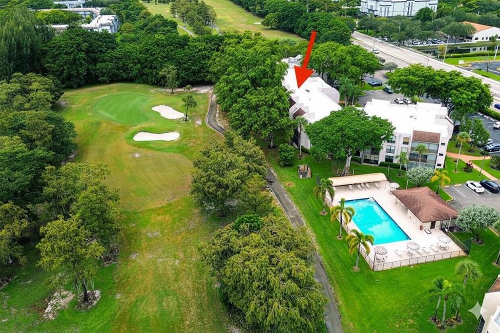 8150 West McNab Road, Unit 312 Tamarac, FL 33321 - Photo 3 of 32 an aerial view of a house with a garden and swimming pool
