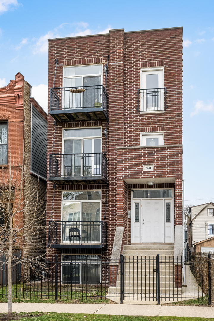 1710 North Whipple Street, Unit 3 Chicago, IL 60647 - Photo 2 of 17 a front view of a house with glass windows
