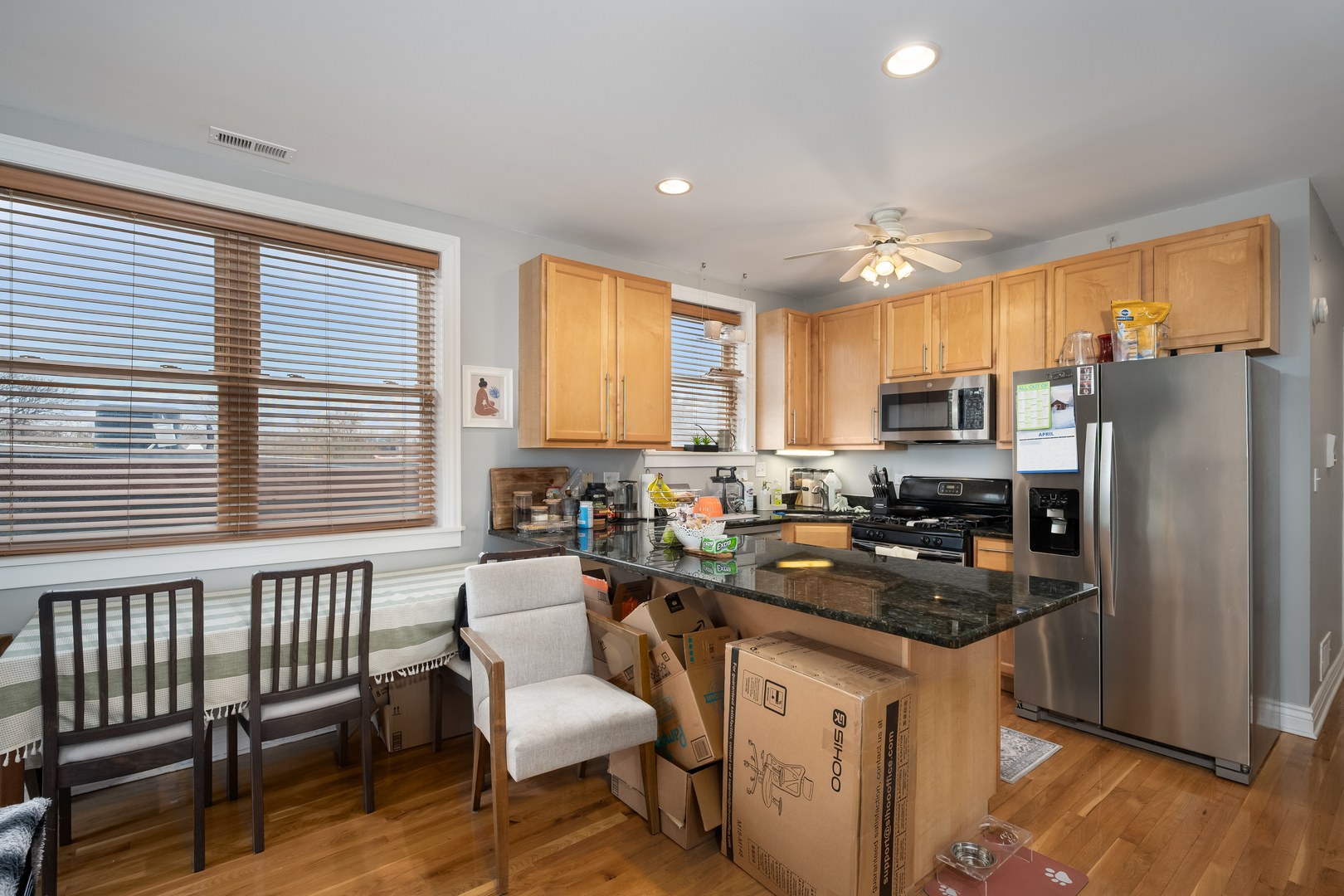 1710 North Whipple Street, Unit 3 Chicago, IL 60647 - Photo 8 of 17 a kitchen with refrigerator a stove a sink a dining table and chairs