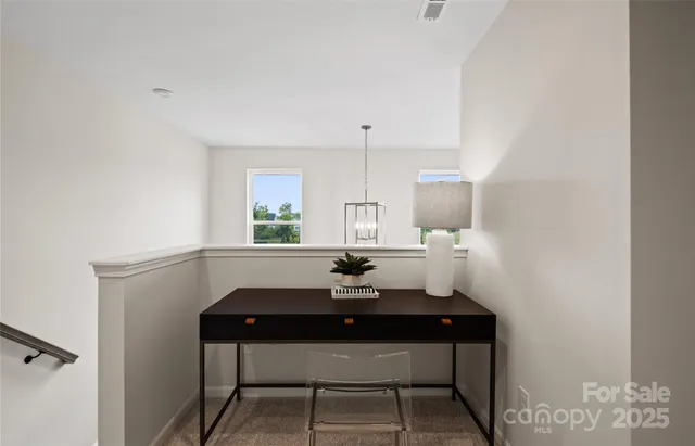 a room with a table chairs and a window