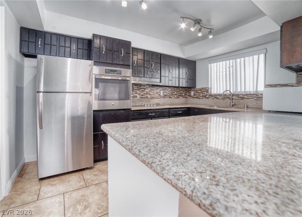 3556 Ruth Drive Las Vegas, NV 89121 - Photo 7 of 21 Granite counters and stainless steel appliances elevate this functional culinary space.