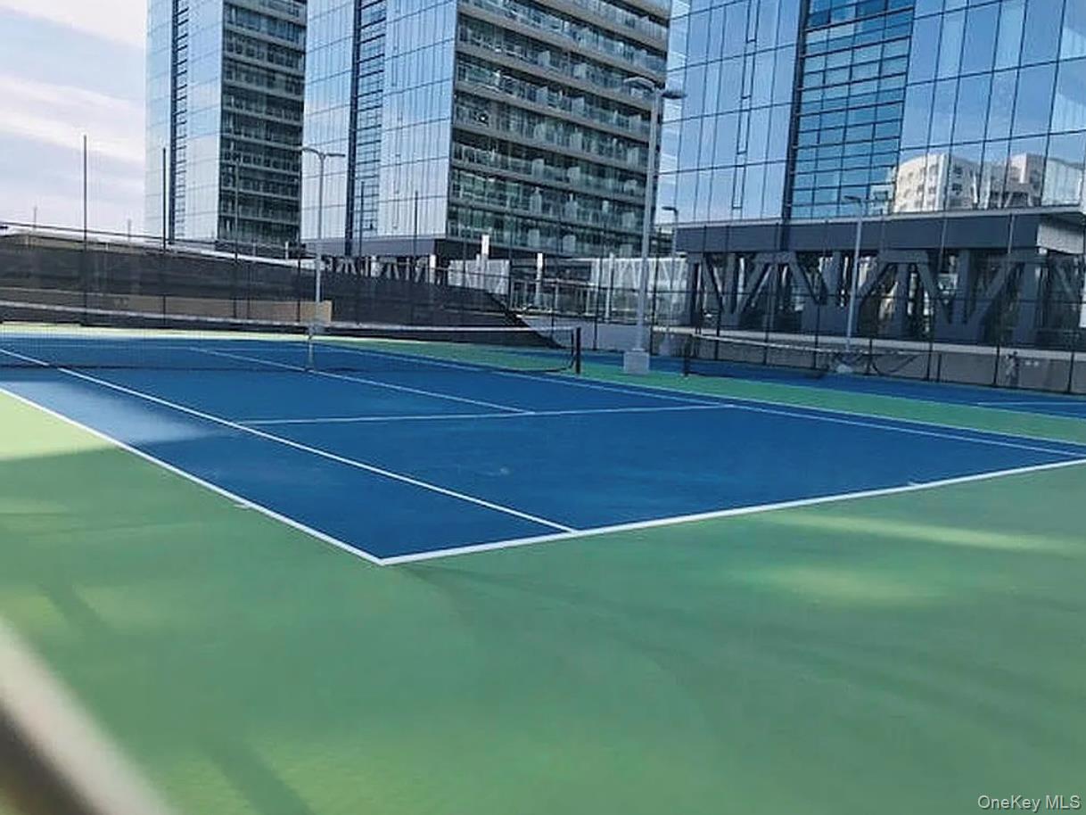 131-03 40 Road, Unit 10H Queens, NY 11354 - Photo 7 of 10 View of tennis court featuring a city view