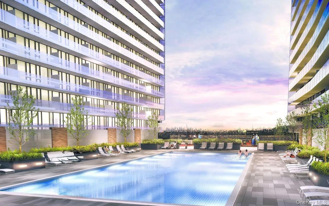 131-03 40 Road, Unit 10H Queens, NY 11354 - Photo 8 of 10 Pool at dusk with a community pool and a patio