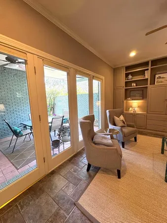 a living room with fireplace furniture and a large window