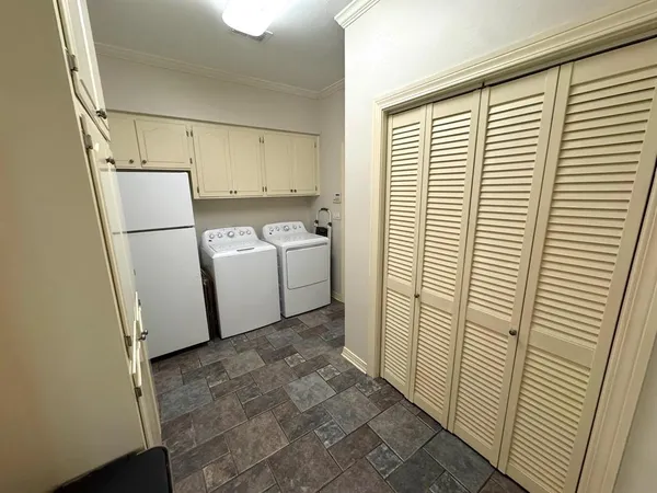 a view of a storage & utility room with a washer dryer