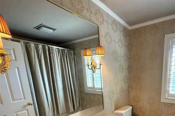 a view of a bathroom with toilet and a window