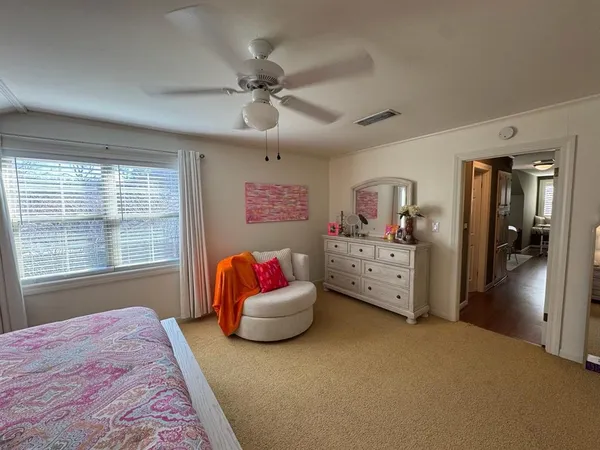 a bedroom with a bed and flat screen tv