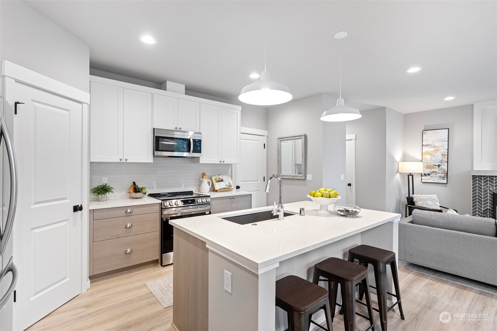 116 161st Street Southeast, Unit 1 Bothell, WA 98012 - Photo 12 of 37 a kitchen with a sink a stove a refrigerator and white cabinets with wooden floor
