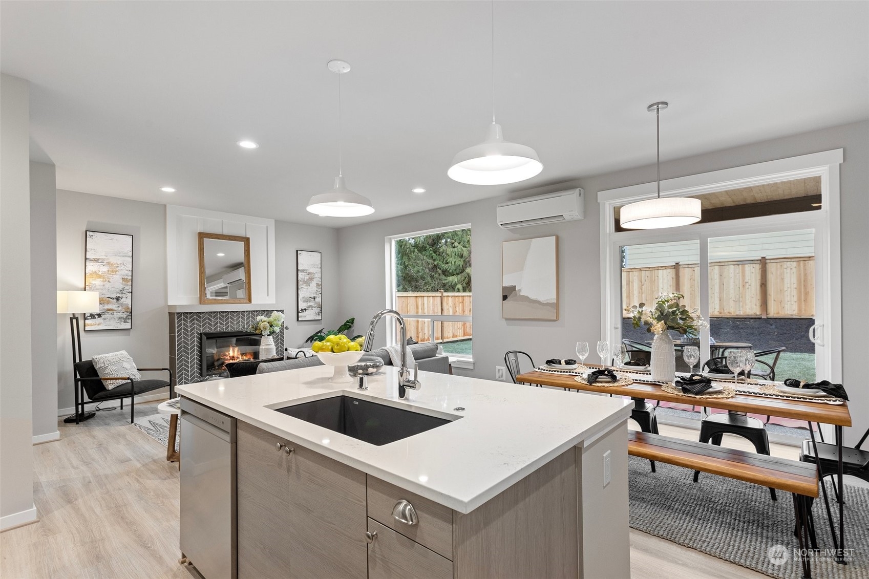 116 161st Street Southeast, Unit 1 Bothell, WA 98012 - Photo 13 of 37 a kitchen with a stove a sink dishwasher a dining table and chairs with wooden floor
