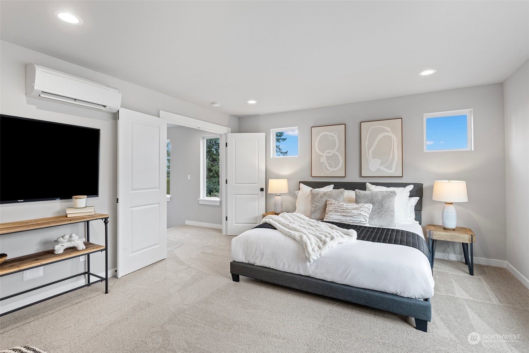 116 161st Street Southeast, Unit 1 Bothell, WA 98012 - Photo 20 of 37 a spacious bedroom with a bed and a flat screen tv