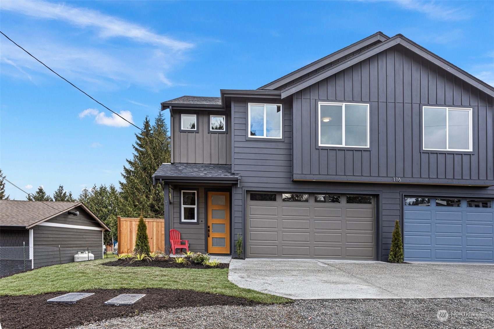 116 161st Street Southeast, Unit 1 Bothell, WA 98012 - Photo 2 of 37 a front view of a house with a yard