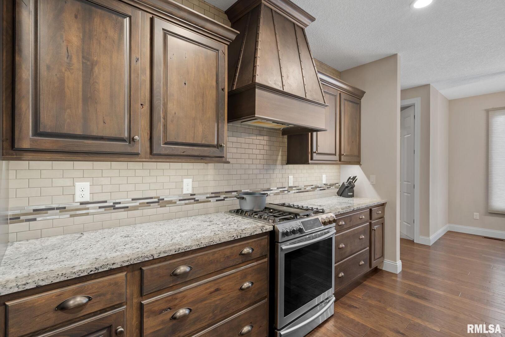 1422 Racine Court Davenport, IA 52804 - Photo 14 of 53 a kitchen with stainless steel appliances granite countertop a sink stove and cabinets
