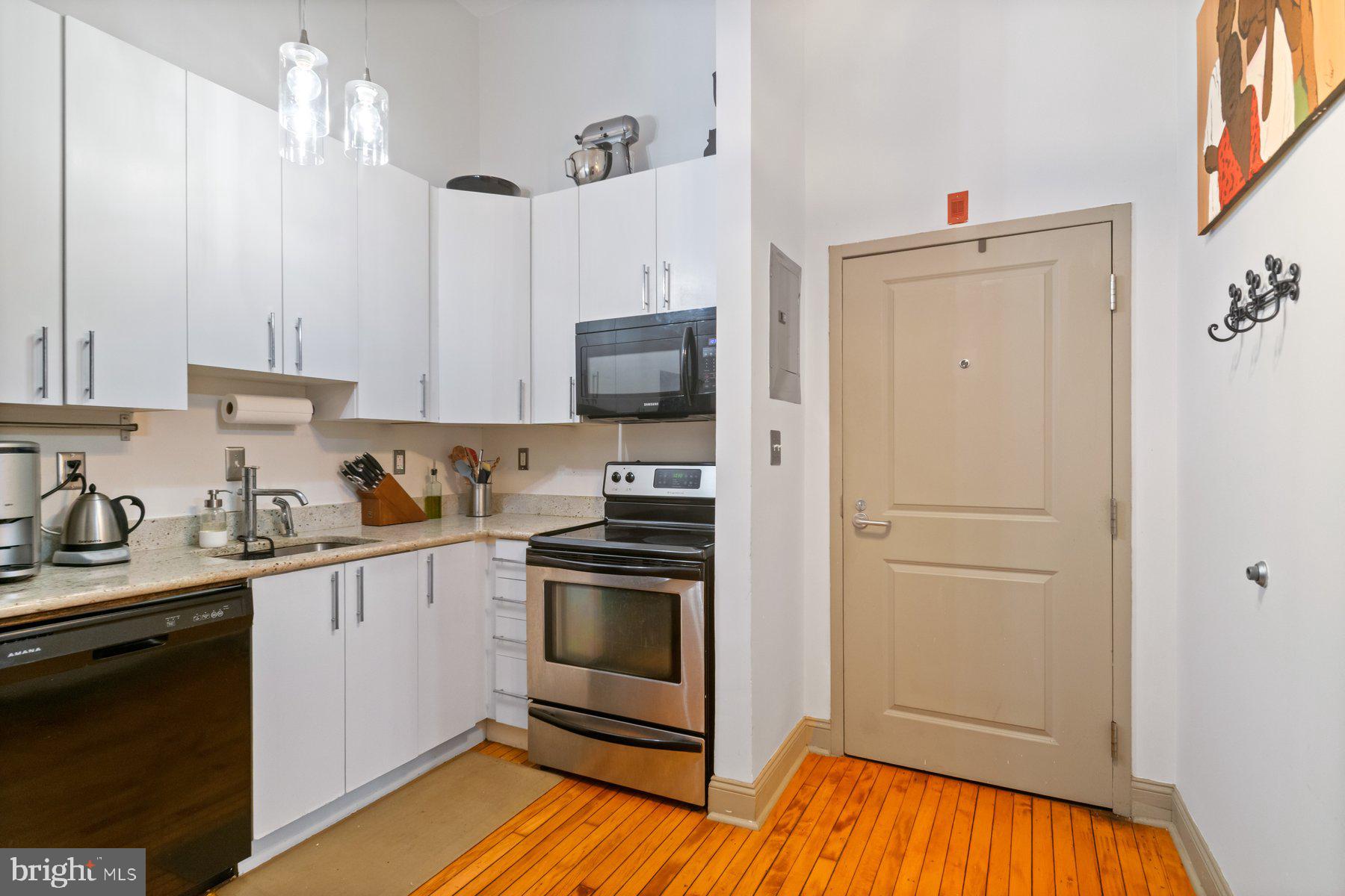 511 South Bond Street, Unit 206 Baltimore, MD 21231 - Photo 15 of 27 a kitchen with stainless steel appliances a stove refrigerator and cabinets