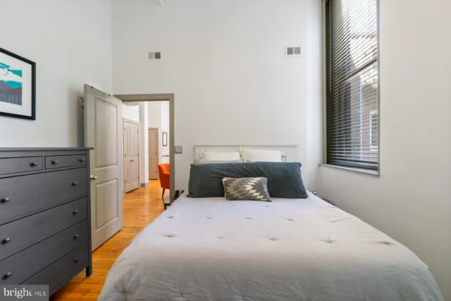 a bedroom with a large bed and a window