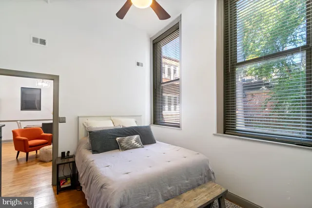 a bedroom with a bed and wooden floor