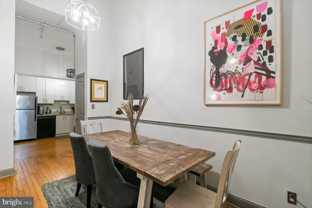 a view of a dining room with furniture and a chandelier