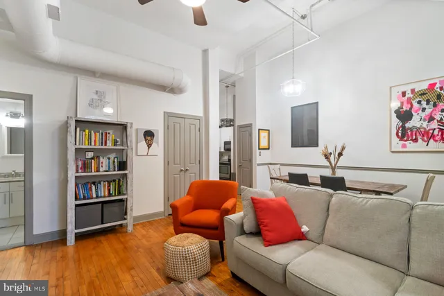 a living room with furniture and a book shelf