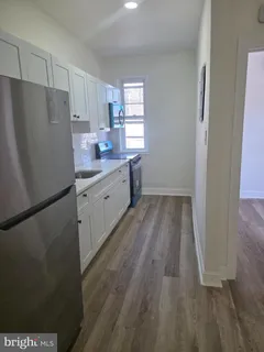 a kitchen with wooden floors and white appliances