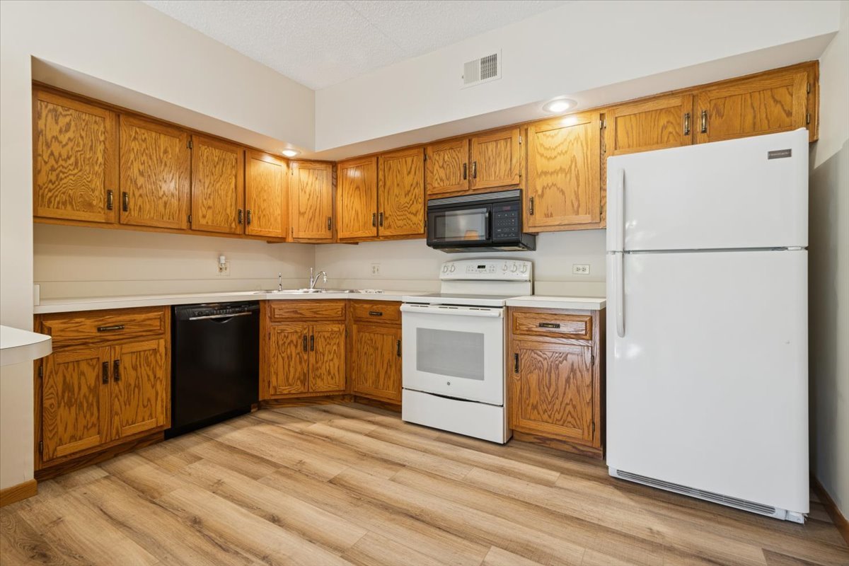 3119 Ingalls Avenue, Unit 2A Joliet, IL 60435 - Photo 5 of 20 a kitchen with a white stove top oven and refrigerator