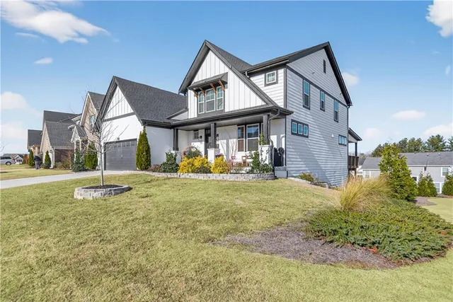 a view of swimming pool with outdoor seating and a back yard