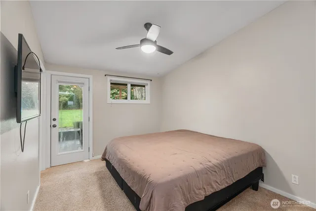 a bedroom with a bed and ceiling fan