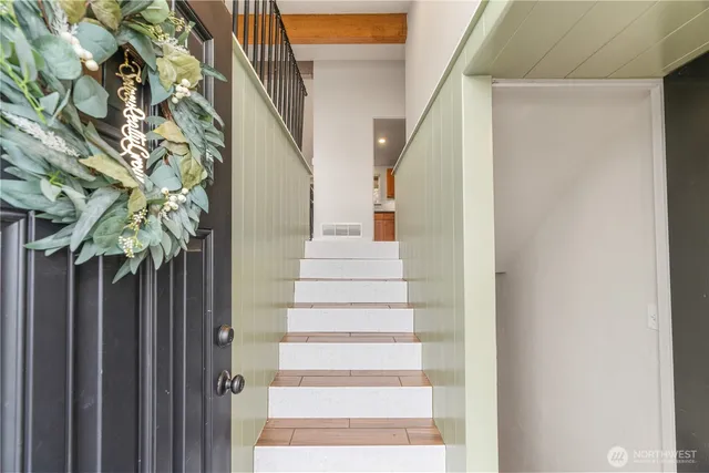 a view of empty room with wooden floor and fireplace