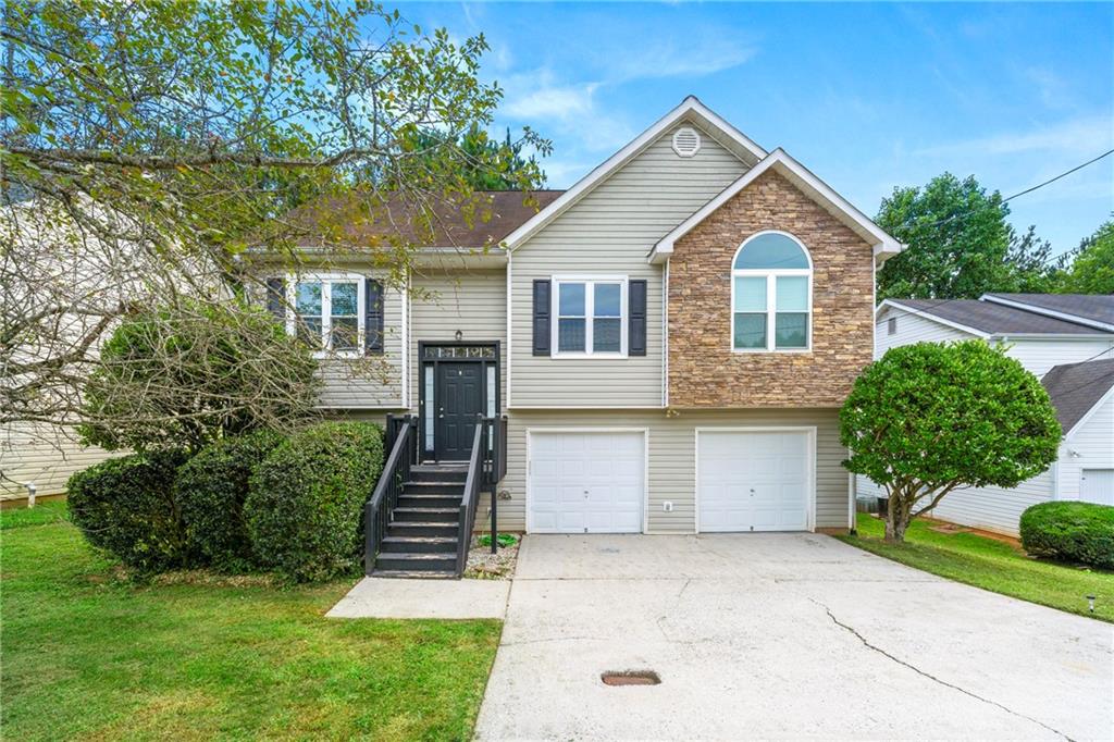 4050 Robin Circle Atlanta, GA 30349 - Photo 1 of 1 Raised ranch featuring a front yard and a garage