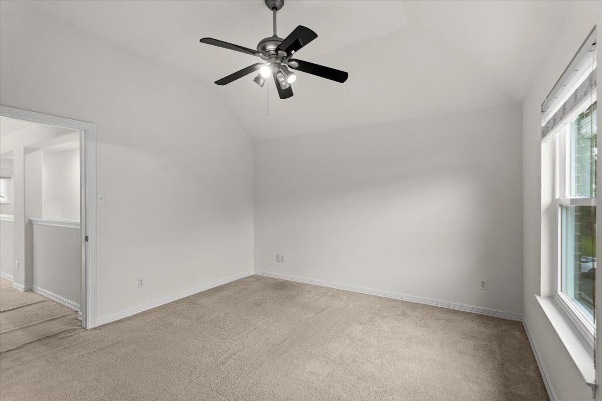 2304 Village View Loop Pflugerville, TX 78660 - Photo 34 of 40 A well-proportioned bedroom with vaulted ceilings and soft carpet awaits your personal touch.