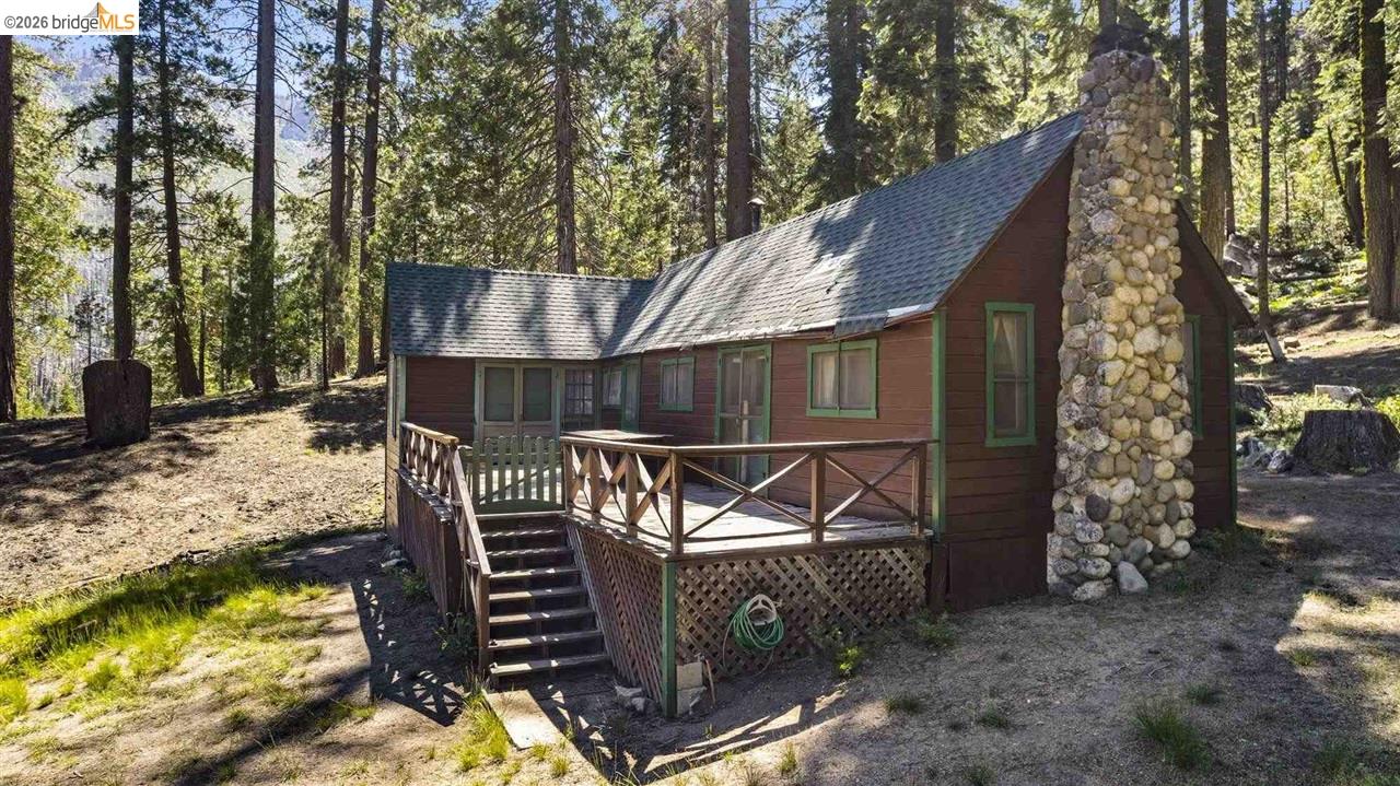 7 Riverside Tract Kyburz, CA 95720 - Photo 1 of 25 a view of a wooden deck with chairs and a yard