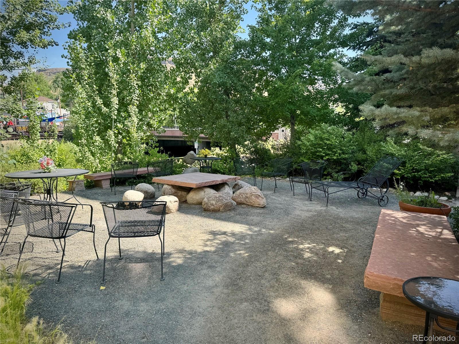 620 11th Street, Unit 306 Golden, CO 80401 - Photo 15 of 22 a view of backyard with seating area and trees