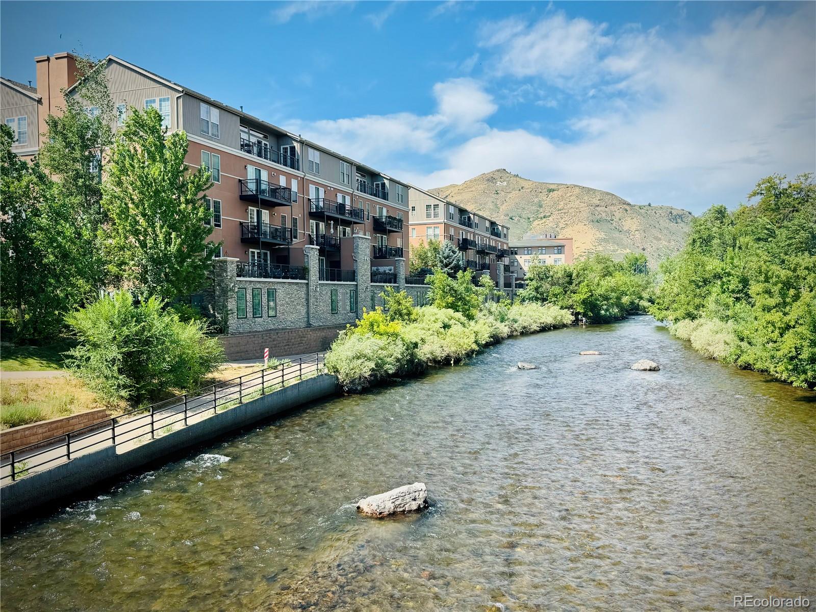 620 11th Street, Unit 306 Golden, CO 80401 - Photo 16 of 22 a view of a lake with a building in the background