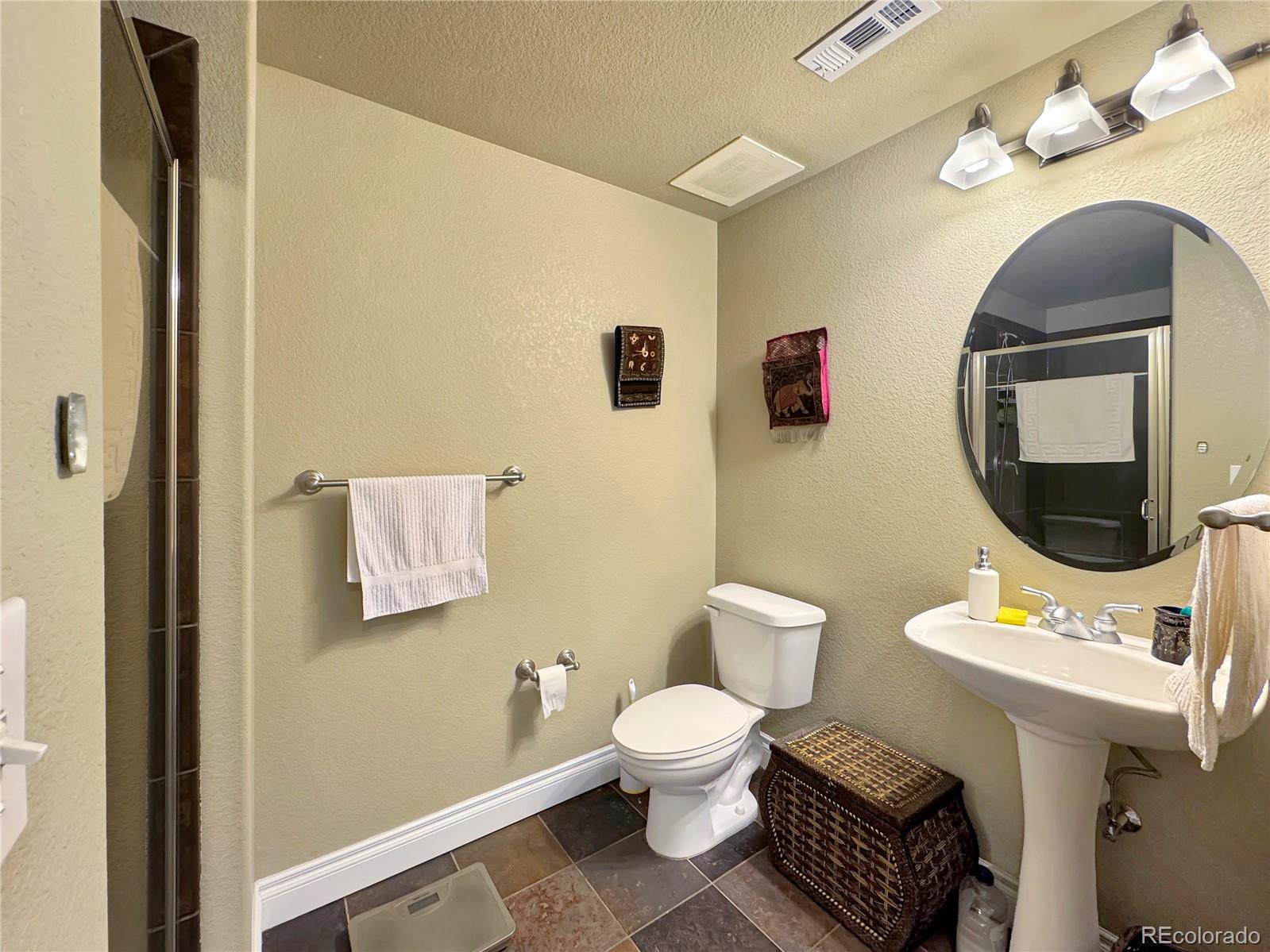 620 11th Street, Unit 306 Golden, CO 80401 - Photo 17 of 22 a bathroom with a toilet sink and mirror