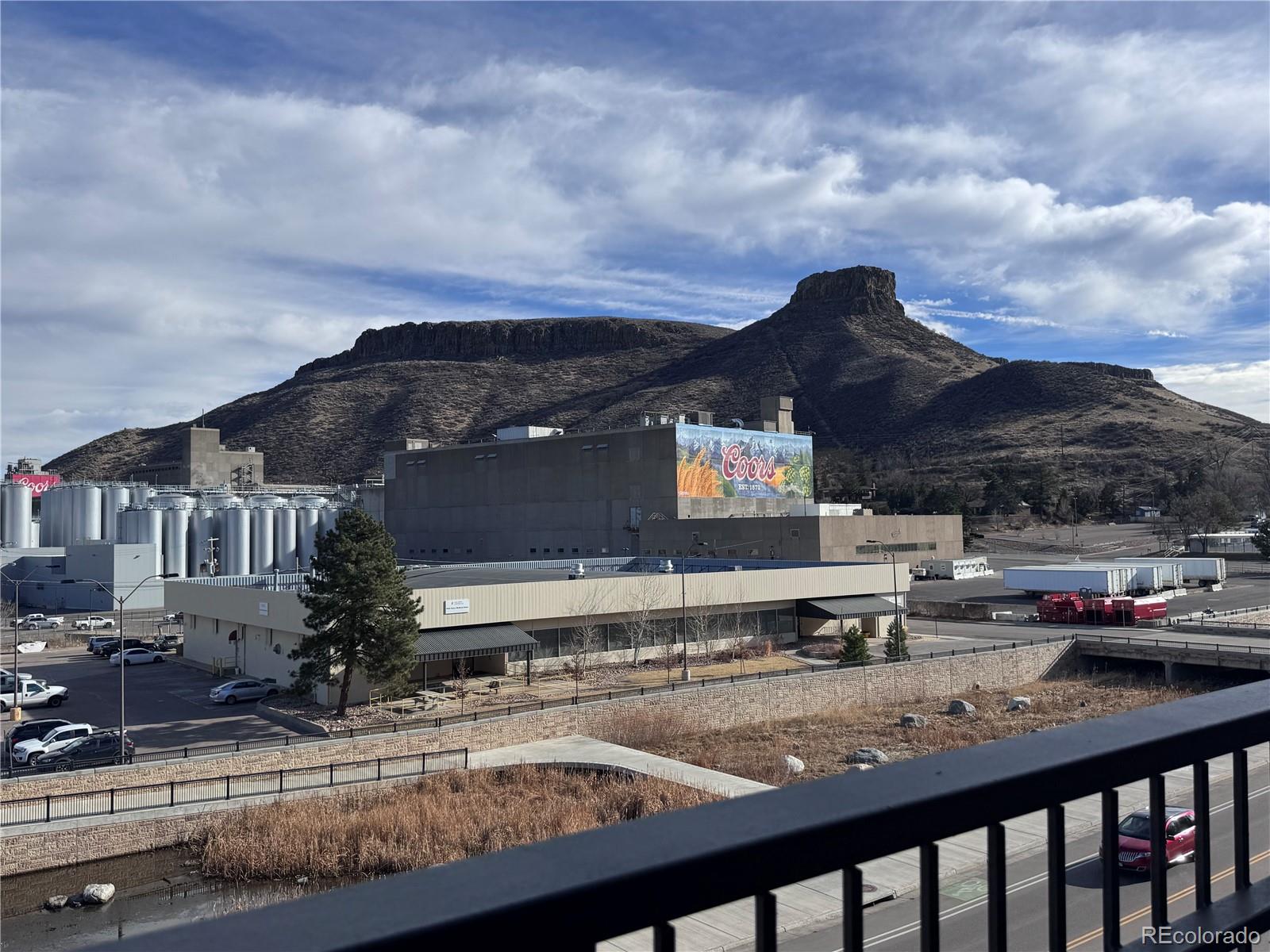 620 11th Street, Unit 306 Golden, CO 80401 - Photo 22 of 22 a view of a house with a cars park on the roadside