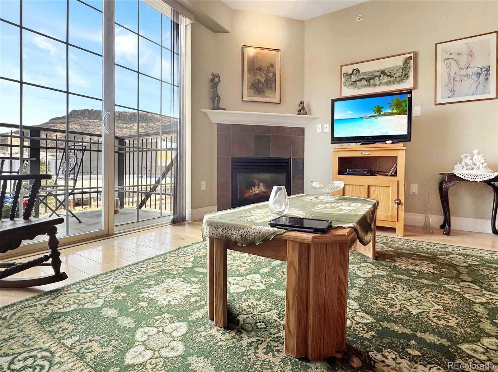 620 11th Street, Unit 306 Golden, CO 80401 - Photo 6 of 22 a view of a dining room with furniture a fireplace and wooden floor
