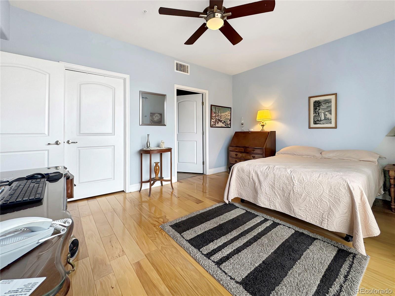 620 11th Street, Unit 306 Golden, CO 80401 - Photo 9 of 22 a bedroom with a bed and wooden floor