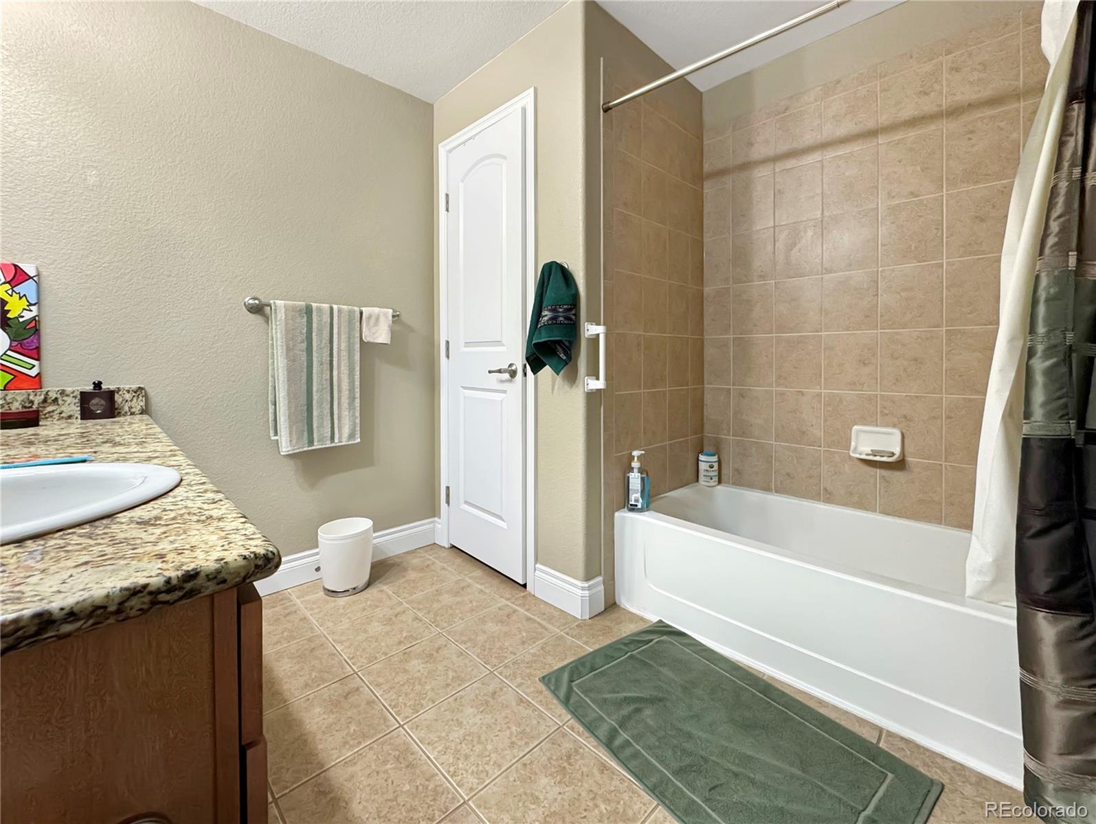 620 11th Street, Unit 306 Golden, CO 80401 - Photo 10 of 22 a bathroom with a granite countertop sink a toilet and bathtub