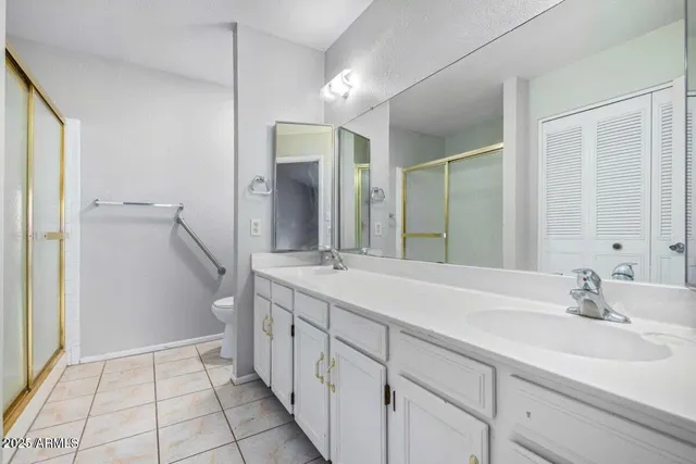 a spacious bathroom with a double vanity sink mirror and a