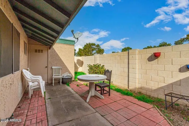 a view of a patio with table and chairs and potted plants